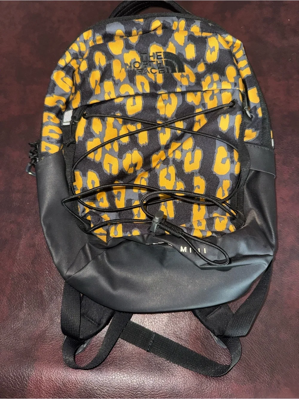 The North Face Black and Yellow Leopard Print Mini Backpack